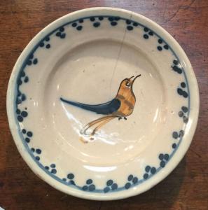 Majolica plate decorated with a stylized bird. Grosso di Albisola manufacture.