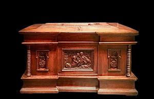 Walnut cabinet with carved bas-reliefs depicting a religious scene ‘Madonna and Child’, putti and rocaille motifs. Netherlands.