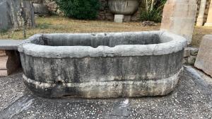 Antique fountain in bush-hammered white marble