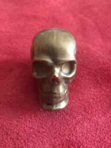 Brass matchbox in the shape of a skull.