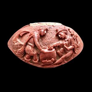 Snuffbox made from a corozo seed with an engraved scene of people.