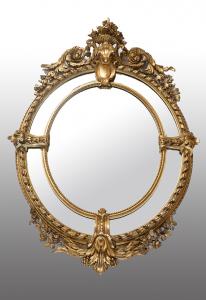 Specchiera antica a medaglione Napoleone III Francese in legno dorato e intagliato. Periodo XIX secolo.