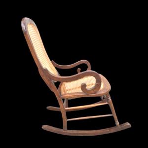 Walnut rocking chair with Vienna straw upholstery.