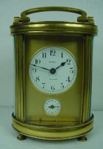 Antique 'officer' table clock with oval case - alarm.