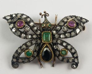 Gold and silver butterfly brooch with diamonds, emeralds, rubies, and sapphire. Early 1900s