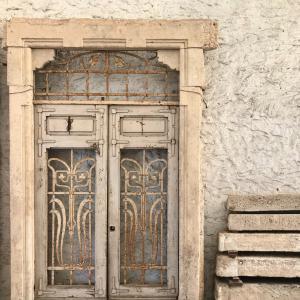 Art Nouveau portal in yellow sandstone with wooden door