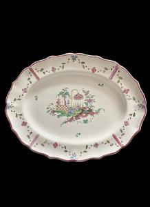 Oval majolica plate decorated with floral festoons around the edge and an oriental-style garden scene in the center. Antonibon factory, Nove di Bassano.