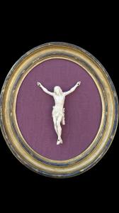 Ivory Christ on oval frame in wood and gold leaf.