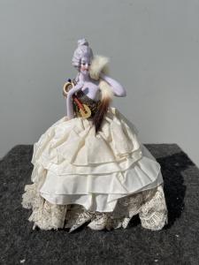 Porcelain 'half doll' powder box with figure of a lady with mandolin and porcelain legs. France or Germany.