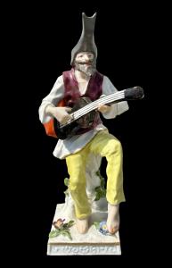 Porcelain guitarist figurine.