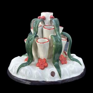 Earthenware tulip vase with floral and leaf motifs.