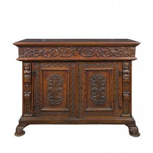 Carved walnut sideboard with compartment. Italy, 17th century.