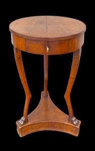 Round walnut three-legged table.