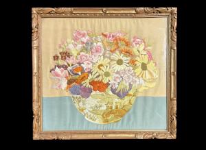 Framed panel with vase of flowers embroidered on fabric.