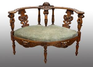 Antique Neo-Renaissance carved walnut tete-a-tete sofa from the late 19th century.