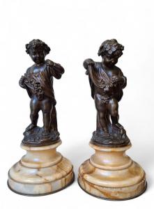 Pair of chiseled bronze cherubs