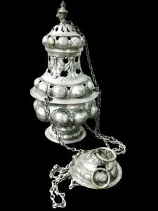 Silver-plated metal censer with perforated design, studs, and stylized leaves.