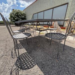 Large handmade wrought iron outdoor table with six chairs. Dimensions: 182 x 112 cm