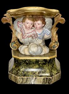 Statue base in carved and painted wood. Front part with a pair of cherubs and rocaille side motifs. Liguria.