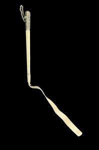 Horse riding crop with silver handle and white leather shaft.