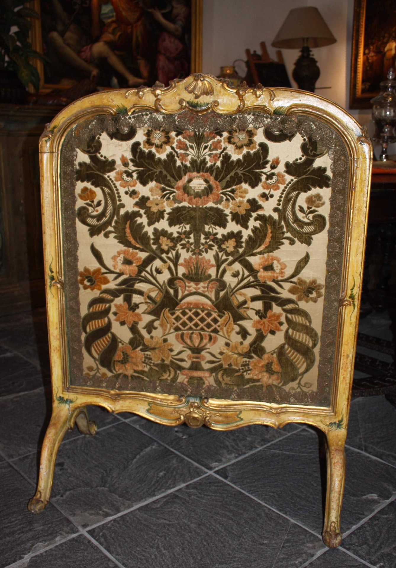 Venice, 18th Century, lacquered and gilded wooden fire screen with fabric embroidered with floral motifs in the center.