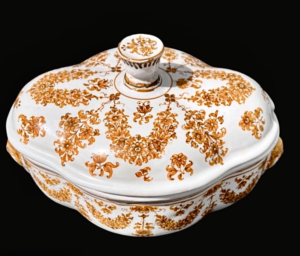 Maiolica tureen decorated with floral motifs and festoons with mask-shaped handles in ochre monochrome. Moustiers, France. Signature Jean Etienne Baron. Olerys and Laugier manufacture.