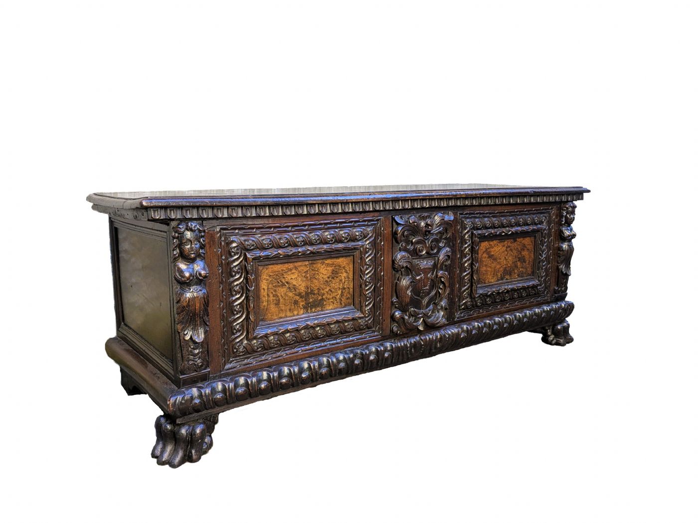 17th-century Lombard walnut chest, richly carved with a coat of arms and burl wood.