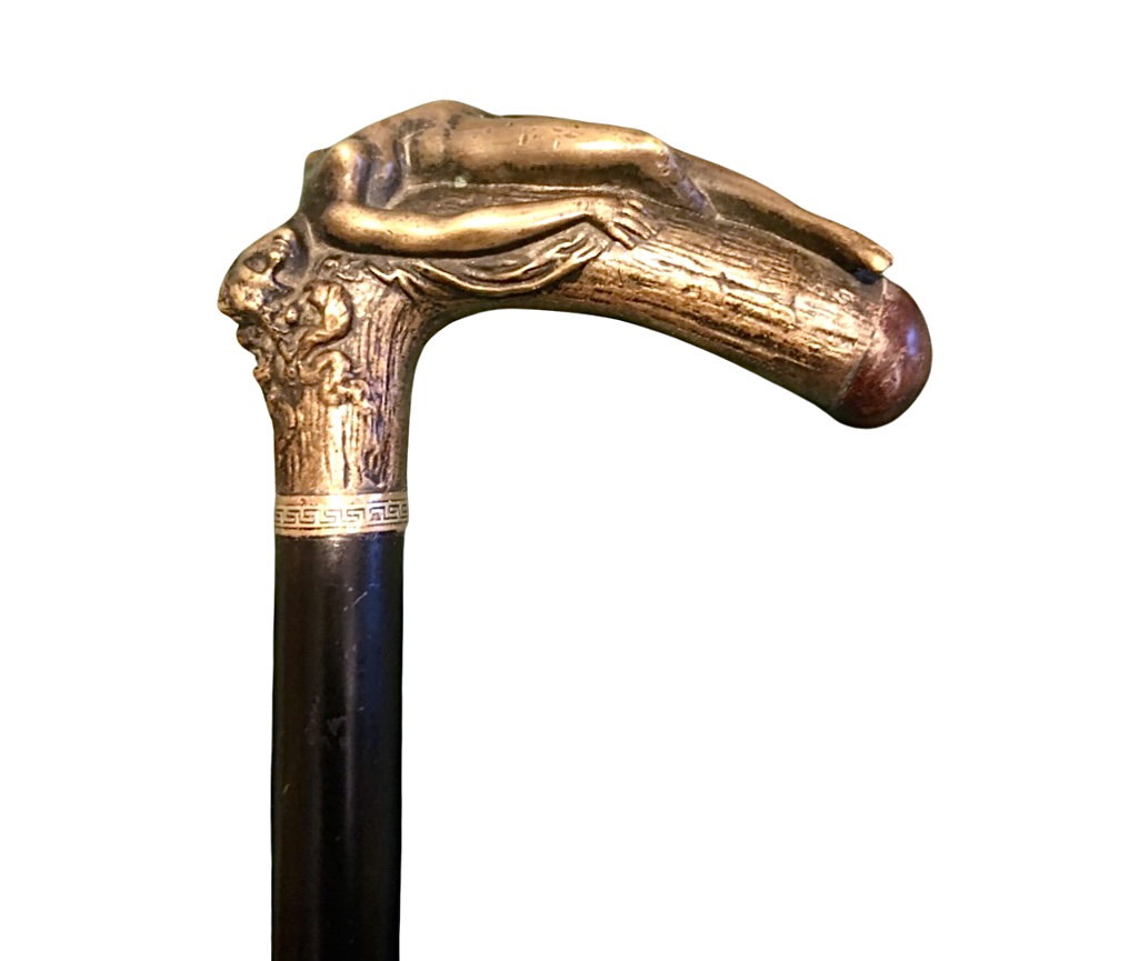 Canne à sujet érotique avec poignée en bronze représentant une femme nue allongée. Extrémité de la poignée en fer plein pour 'autodéfense'. Fût en ébène.