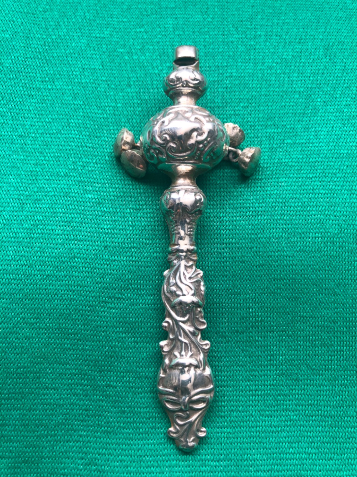 Silver baby rattle with stylized Art Nouveau floral motifs. USA.