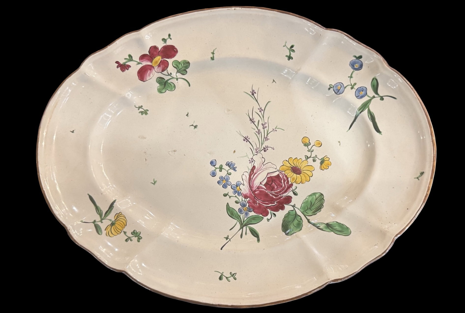 Oval majolica plate decorated with a 'rose' design. Finck Manufacture. Bologna.