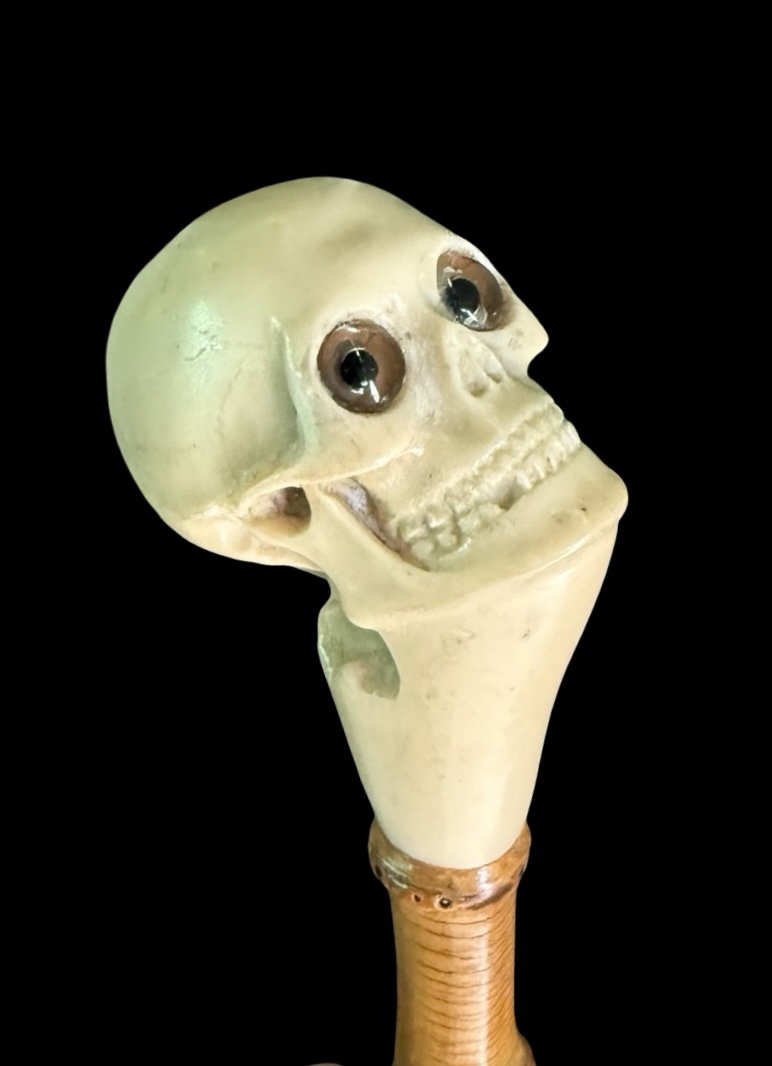 Cane with a skull-shaped bone knob.