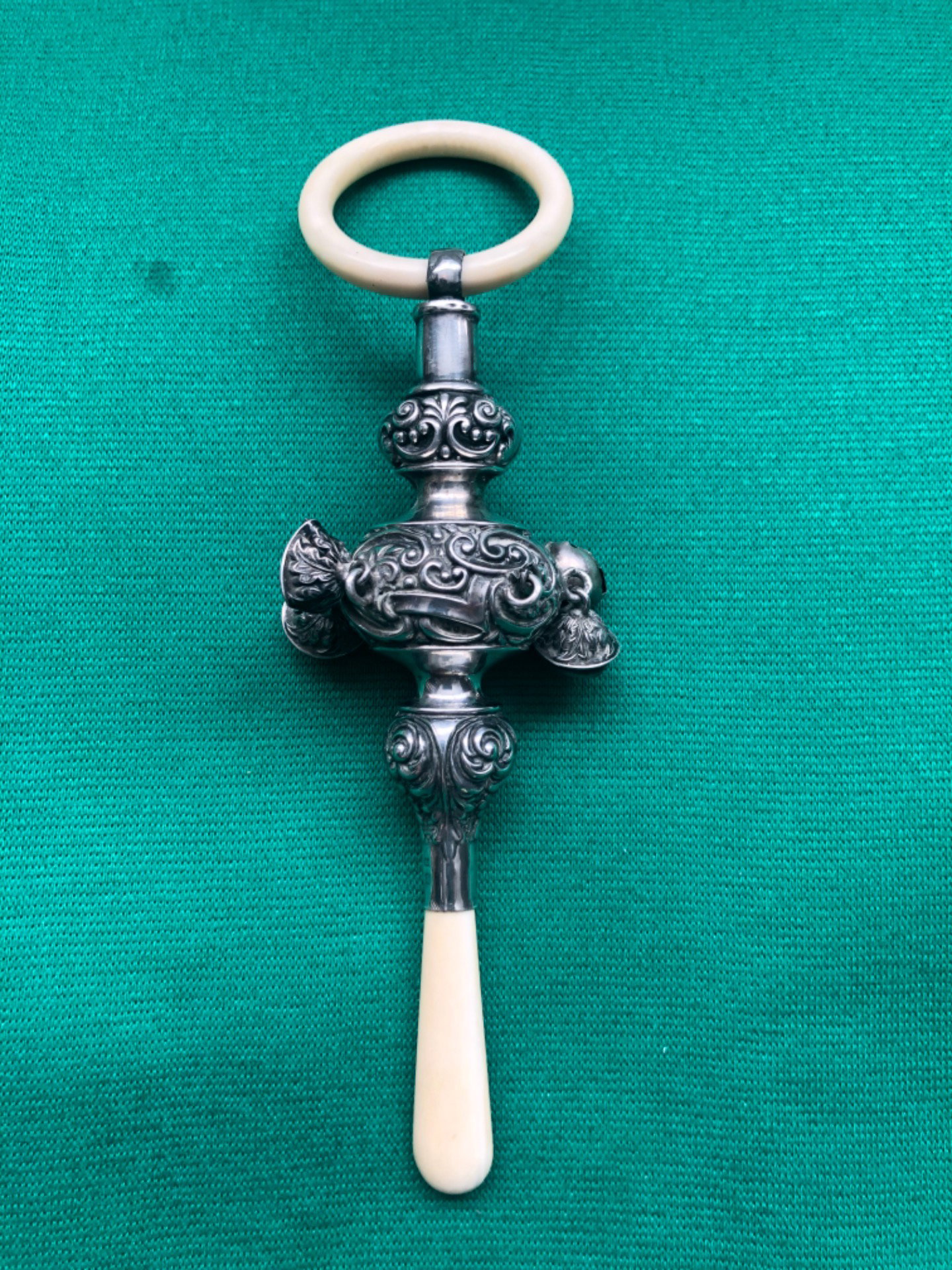 Silver baby rattle with stylized plant motifs. Birmingham 1904, England.