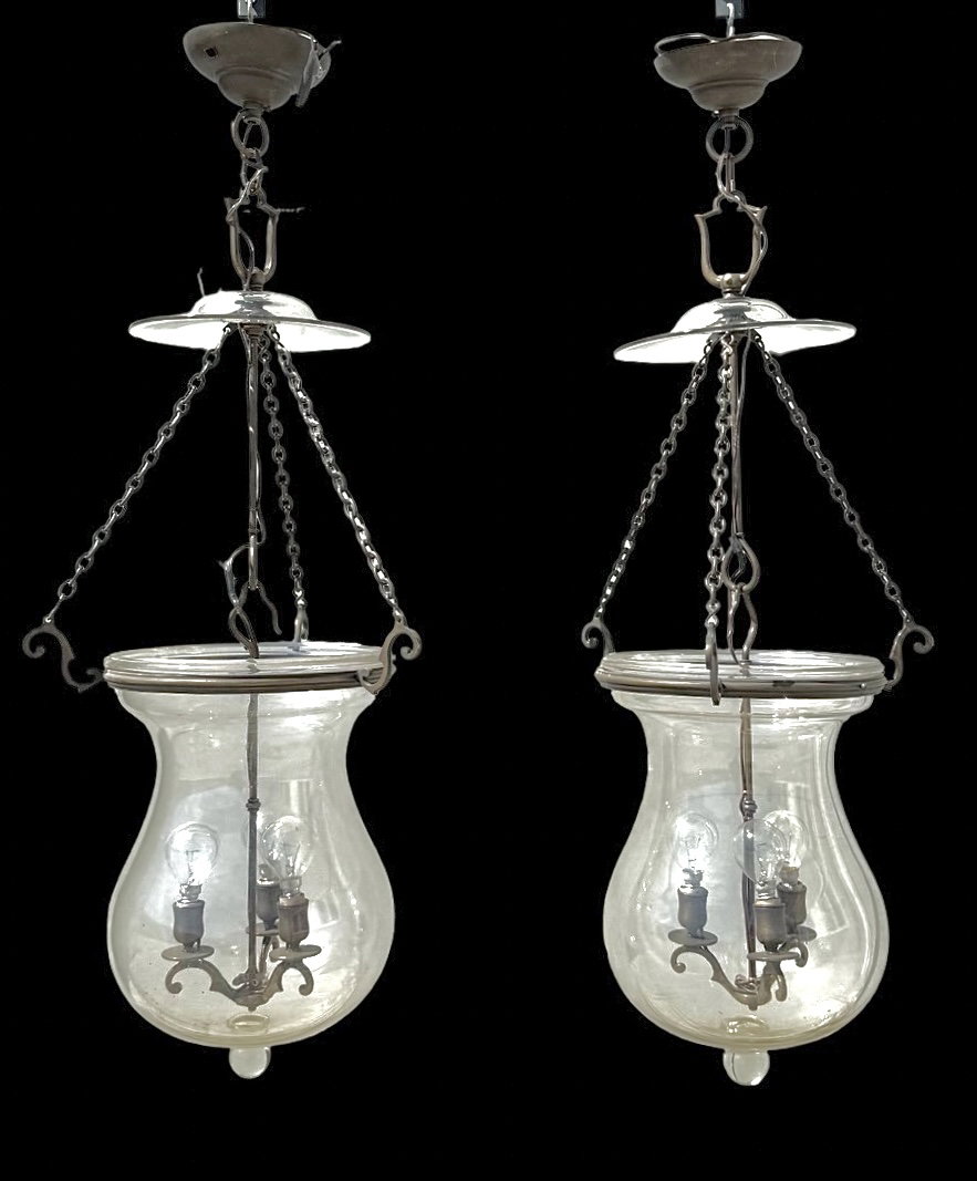 Pair of three-light pendant lamps in clear blown glass.