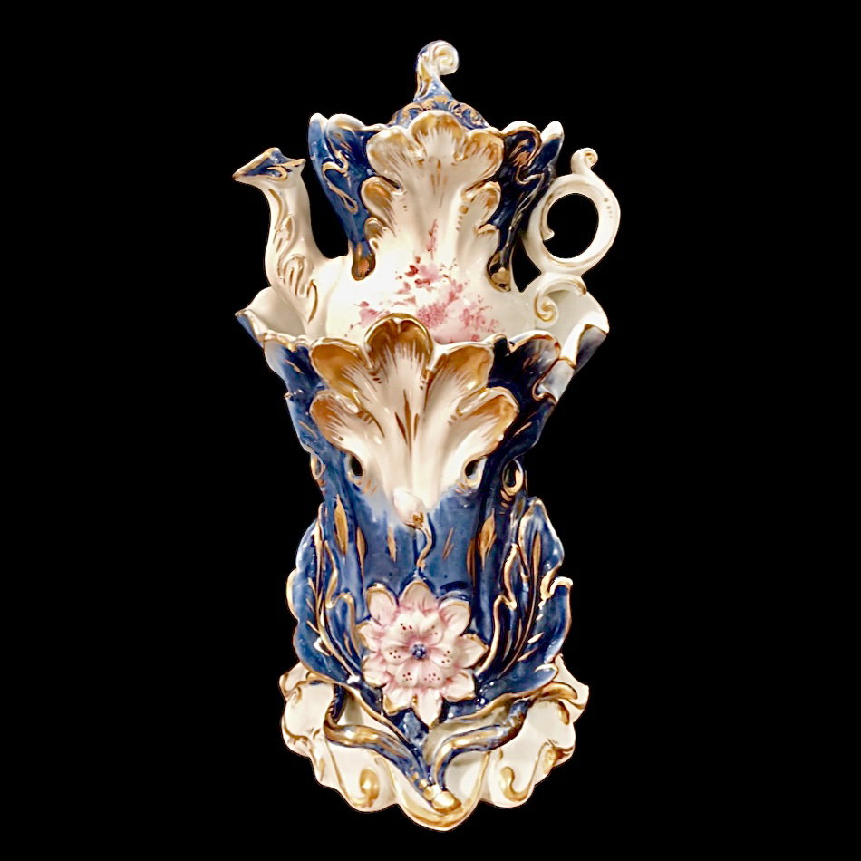 Porcelain teapot warmer with gold highlights, floral decoration, and raised vegetal and floral motifs. France.