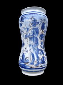 Maiolica albarello decorated with a male figure against a rocky background in turquoise monochrome. Naples.