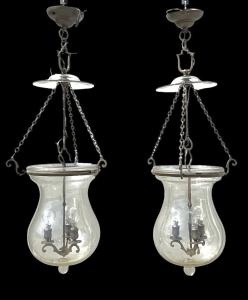 Pair of three-light pendant lamps in clear blown glass.