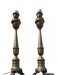 Pair of bronze candlesticks converted into lamps with three leonine feet and stem with stylized leaves.