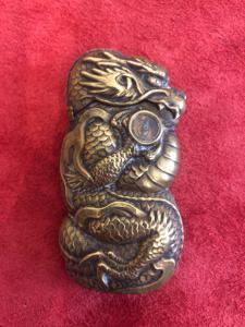 Brass matchbox with oriental dragon and compass.