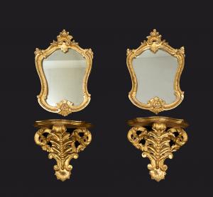 Pair of antique consoles with attached gilded and carved wood mirrors. Rome, 19th century.