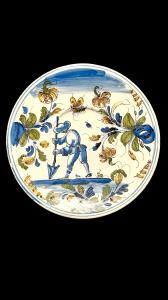 Majolica plate with a figure of a farmer in a rural setting. Pavia.