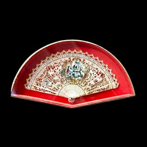 Fan with pierced bone sticks with gold highlights and painted gallant scene. France.