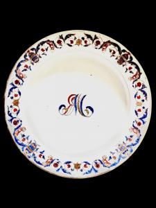 Pair of majolica plates with decoration of stylized vegetable and geometric motifs and human figures. Pasquale Rubati manufacture. Milan.
