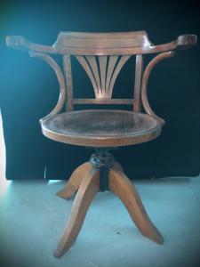 Light wood chair, adjustable in height.
