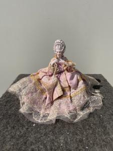 Porcelain 'half doll' powder box with figure of a lady with parasol. France or Germany.
