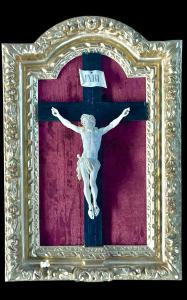 Ivory Christ on ebonized cross with carved wood and gold leaf frame.