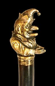Stock mit Bronzegriff, der einen Hanswurst darstellt.