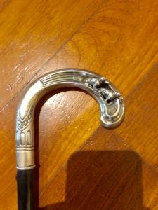 Cane with openwork silver handle featuring two embossed dachshunds.