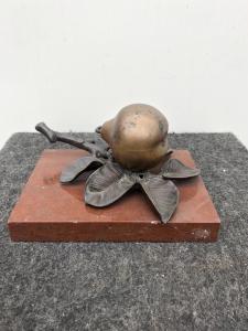 Bronze inkwell in the shape of a pear on a marble base.