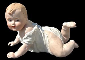 Kindfigur 'Piano Baby' aus polychromer Bisquitporzellan. Manufaktur Heuback, Deutschland.