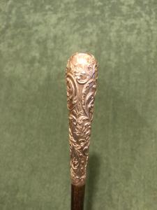  Bastone con impugnatura in argento con decoro floreale e rocaille.